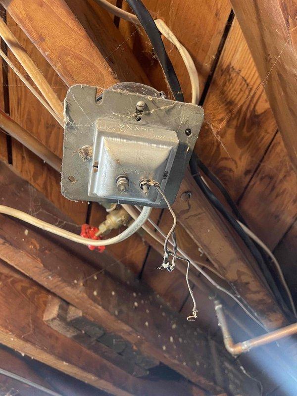 Conducted assessment of outdoor flood lights and evaluated requirements for doorbell electrical connection and exterior outlet installation. Inspected junction box in unfinished space, noting existing wiring configuration and structural mounting. Documented electrical pathways and connection points to determine optimal routing for new exterior applications.