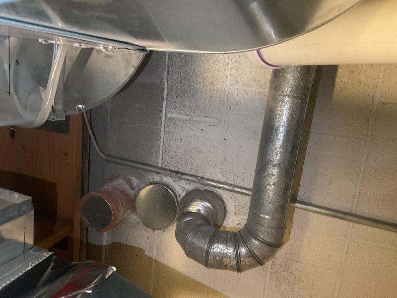 Performed diagnostic service on 8-year-old tanked water heater exhibiting intermittent hot water supply issues. Inspected the "Defender System" and associated copper/PVC piping configuration. Identified and addressed mineral buildup in the heat exchanger affecting temperature consistency, restoring proper hot water functionality.