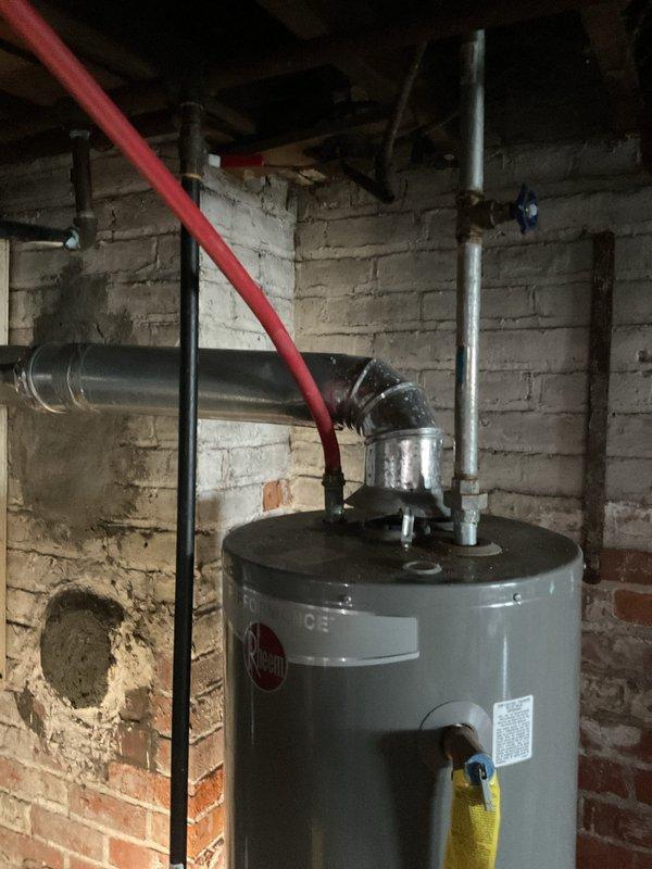 Responded to no hot water call at 8-year-old unit in basement. Installed new Rheem Performance water heater with proper venting system and connected all required supply lines. System now functioning properly with hot water restored.