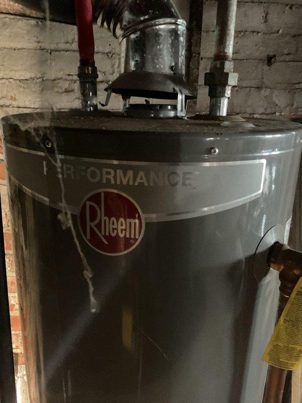 Responded to no hot water call at 8-year-old unit in basement. Installed new Rheem Performance water heater with proper venting system and connected all required supply lines. System now functioning properly with hot water restored.