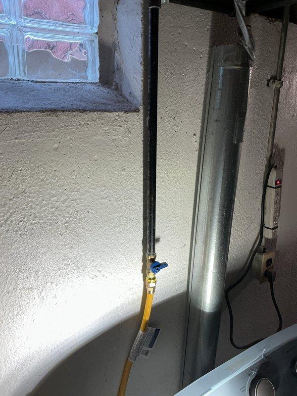 Completed installation of customer-supplied laundry tub faucet in basement, installed washer hookups with shut-off valve, and connected gas lines with shut-off valves for kitchen stove and basement dryer. All connections were tested for proper function and leaks to ensure safe operation of all fixtures.