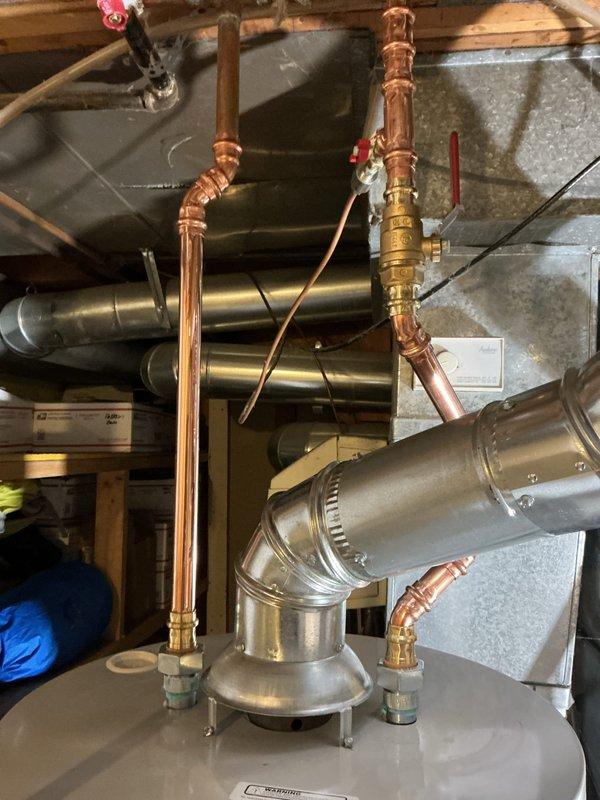 Successfully completed installation of gas hot water heater with proper venting in utility area. Work included connecting copper supply lines with brass valves and fittings, installing galvanized steel ventilation ducts, and ensuring all connections were secure and functional. Final inspection confirmed proper operation of the unit with no leaks.