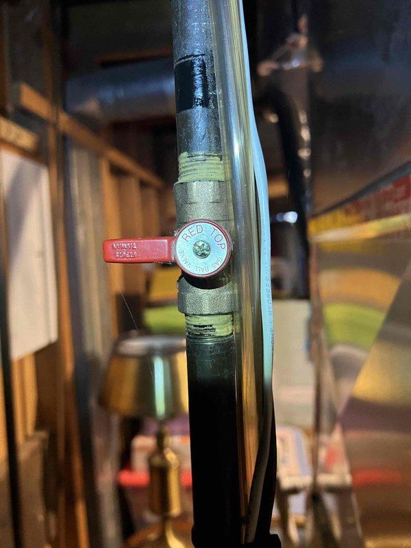 Responded to no heat call for a 13-year-old furnace located in basement. Performed diagnostic testing with multimeter, measuring electrical parameters at 10.11V. Inspected gas valve system, noting significant corrosion on connecting pipes near the RED TOP valve, which was affecting proper gas flow to the heating system. Cleaned connections and restored proper heat output to resolve the customer's complaint.