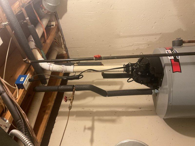 Responded to service call for no hot water in basement water heater. Upon inspection, diagnosed issues with the water heater's supply lines and valve assembly. Installed new insulated pipes, replaced damaged PVC connections, and serviced the control unit to restore proper hot water function.
