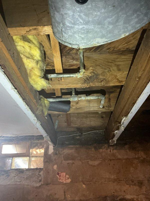 Performed comprehensive inspection of cast iron piping system requiring replacement from basement to upper level. Examined exposed structural areas with existing galvanized components and identified multiple sections of deteriorated cast iron pipes. Assessed bathroom plumbing configuration including shower valve assembly and access points for integration with new piping system.