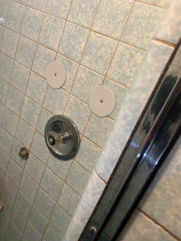 Performed comprehensive inspection of cast iron piping system requiring replacement from basement to upper level. Examined exposed structural areas with existing galvanized components and identified multiple sections of deteriorated cast iron pipes. Assessed bathroom plumbing configuration including shower valve assembly and access points for integration with new piping system.