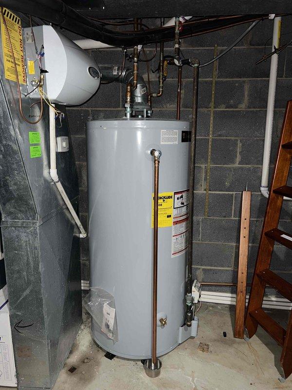 Replaced aging water heater in basement of 80-year-old home where persistent leak had been occurring for several weeks. Installed new unit with proper copper piping connections and verified operation of associated AprilAire system. All work completed to code and system received necessary inspection approvals.