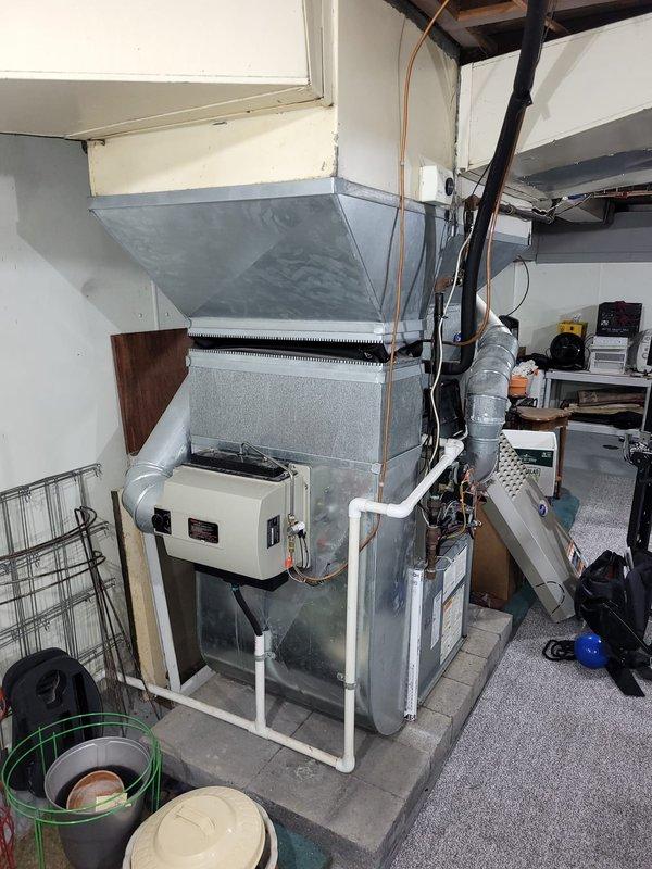 Performed comprehensive evaluation of 25-year-old HVAC system located in residential basement. Diagnosed multiple critical failures including failed heat exchanger, locked inducer motor, and weak blower motor capacitor in the 2005 furnace/AC system. Provided detailed estimate for complete system replacement of both furnace and air conditioning unit, documenting existing installation configuration and ductwork layout for proper replacement specifications.