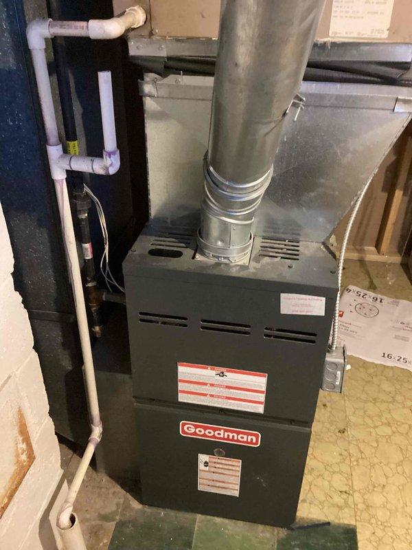 Provided estimate for replacement of 10+ year old Goodman gas furnace located in basement. Current unit is operational but showing signs of age. Noted PVC venting requirements and evaluated existing ductwork connections. Documented basement utility area conditions including water staining and wall deterioration near installation location.