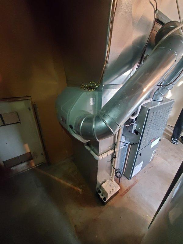 Responded to service call for unusual noise from 15+ year old furnace located in basement. Upon inspection, found the unit to be in relatively good condition with no visible damage or deterioration to the ducting or main components. Checked Honeywell thermostat which was functioning properly, displaying correct temperature and humidity readings. Performed standard diagnostic procedures, identified and eliminated source of noise.