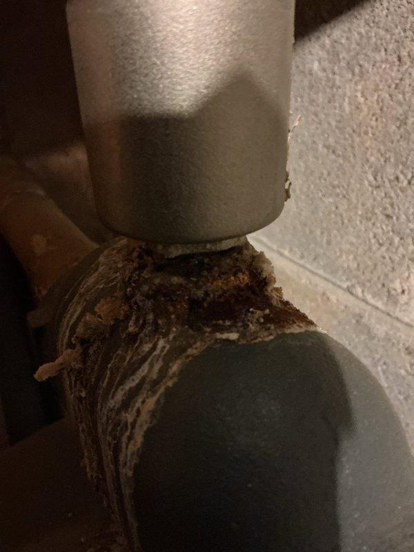 Performed Gold Boiler Inspection and identified significant corrosion at pipe connections with visible water leakage from the unit. Documented extensive deterioration at joint areas with rust and mineral deposits, particularly around the expansion tank connection to copper piping. Photos were taken to document the condition for further assessment of repair needs.