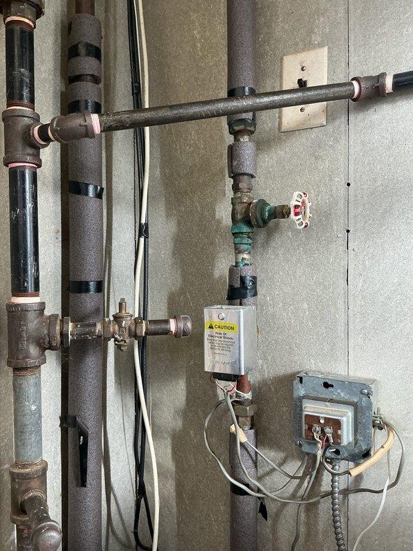 Performed Gold Boiler Inspection on 21-year-old hot water boiler located in basement. System was operational with proper pressure readings observed. Inspected plumbing connections, insulation integrity on pipes, and verified functionality of shut-off valves and control module.