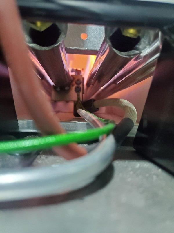 Responded to no heat call for a new heating system located in basement. Upon inspection, identified issue with heat exchanger tubes experiencing improper combustion as evidenced by orange/reddish glow. Also noted pressure regulator/valve assembly required adjustment to restore proper system function.