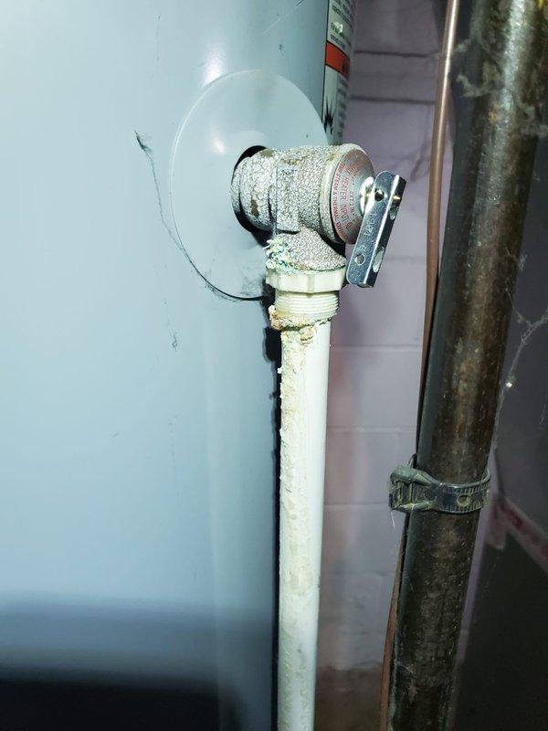 Responded to service call for furnace blowing cool air. Diagnosed issue with Evcon furnace in basement and found water heater in close proximity with visible mineral deposits around connections. Completed necessary repairs to restore proper heating function.