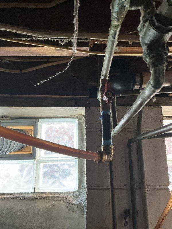 Diagnosed and serviced tankless water heater displaying error code 12. Inspected internal components including circuit board, wiring, and heat exchanger. Identified potential issues with water supply lines and examined nearby plumbing infrastructure, noting interaction between newer copper pipes with brass fittings and older galvanized metal pipes in the system.