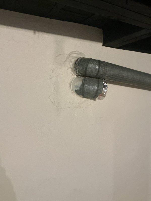 Repaired water leaks in laundry room and bathroom sinks by replacing damaged PVC drain pipes and connectors showing visible water damage. Addressed water heater backdrafting issue in 50-gallon unit by inspecting and resealing improper wall penetrations where galvanized pipes enter, which were contributing to the backdraft condition.