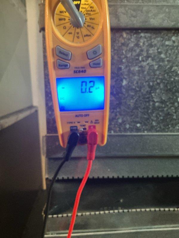 Responded to service call for furnace system that was running continuously and not maintaining set temperature. Diagnostic testing with Fieldpiece SC640 multimeter revealed microamp readings of 0.2 and -2.2μA on the flame sensor circuit, indicating contamination. Cleaned and reinstalled flame sensor, restoring proper flame rectification values and resolving the continuous run issue.