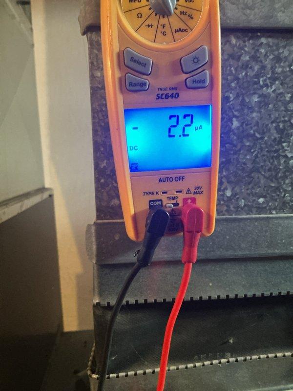 Responded to service call for furnace system that was running continuously and not maintaining set temperature. Diagnostic testing with Fieldpiece SC640 multimeter revealed microamp readings of 0.2 and -2.2μA on the flame sensor circuit, indicating contamination. Cleaned and reinstalled flame sensor, restoring proper flame rectification values and resolving the continuous run issue.