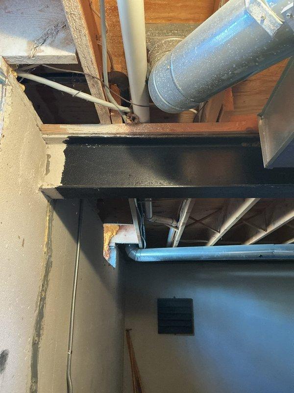 Responded to violation correction call #248-563-2430. Conducted inspection of basement mechanical area, documenting condition of HVAC ductwork, insulation integrity on metal and PVC piping systems, and examining electrical connections at junction box. Photos taken show exposed structural elements with proper clearance for mechanical systems and no visible code violations present after service completion.