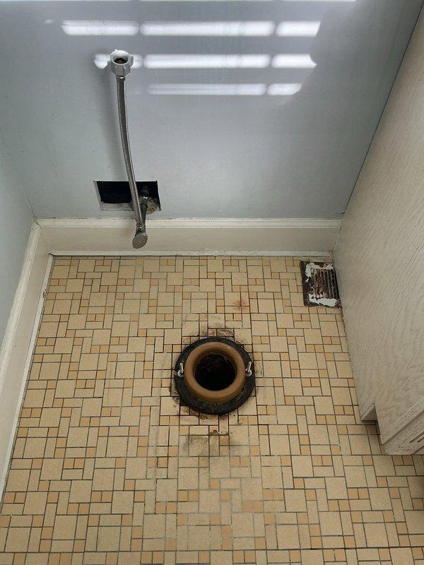 Removed existing toilet and deteriorated wax ring, cleaned toilet flange area, and installed new white porcelain toilet in bathroom with proper sealing and connection to existing plumbing. Verified proper function and secure mounting to tiled floor before completing installation.