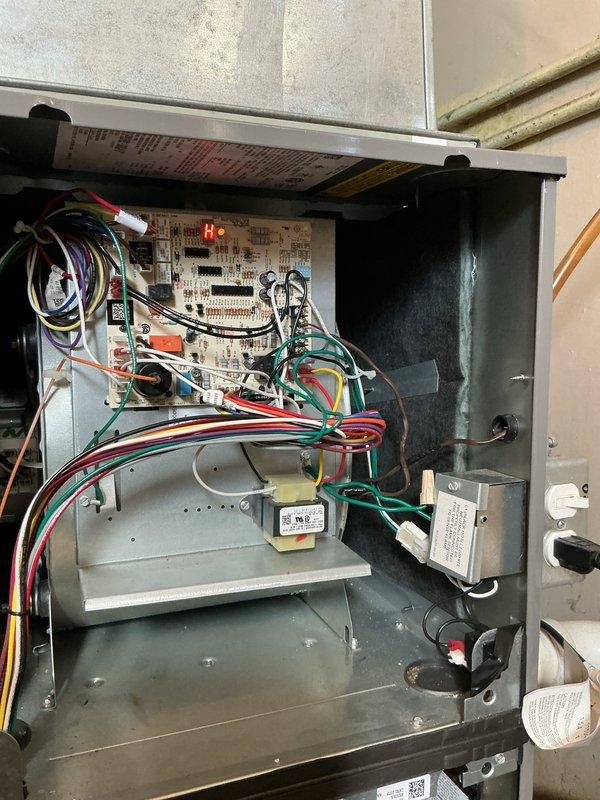 Diagnosed and repaired a 1-year-old furnace experiencing short cycling due to fault code H H29. Inspection of the control board revealed illuminated red LED indicator, confirming control system malfunction. Resolved issue by repairing exposed electrical connections in the utility room that were causing intermittent signal disruption to the furnace control module.