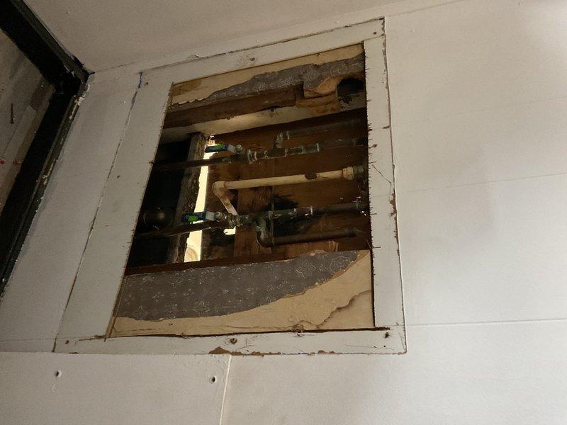 Conducted comprehensive assessment of shower plumbing system, identifying need for complete piping replacement. Accessed internal plumbing through wall cut-out, evaluated existing PVC and copper pipe condition, and installed new shower fixture with brass valve component. Work included removal of damaged sections and installation of upgraded piping system to ensure proper water flow and prevent future leaks.