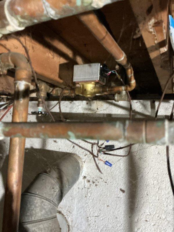 Conducted assessment of 50+ year old hot water boiler system in basement that is currently operational. Inspection revealed aging copper supply lines with visible tarnishing, outdated control valves, and electrical components that would benefit from modernization. Recommended replacement of existing natural gas boiler system with current high-efficiency equipment to improve reliability and energy performance.
