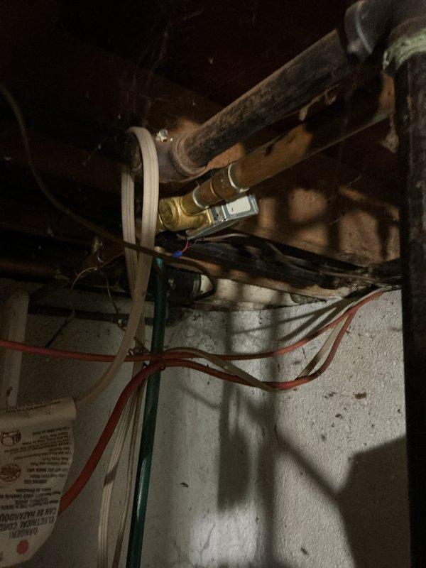 Conducted assessment of 50+ year old hot water boiler system in basement that is currently operational. Inspection revealed aging copper supply lines with visible tarnishing, outdated control valves, and electrical components that would benefit from modernization. Recommended replacement of existing natural gas boiler system with current high-efficiency equipment to improve reliability and energy performance.