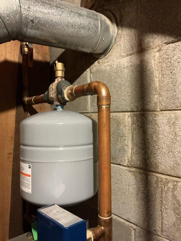 Replaced failed expansion tank and air vent in customer's hydronic heating system. Installed new expansion tank with proper connection to copper supply lines and verified proper system pressure. Air vent replacement eliminated air entrapment issues, restoring optimal system operation and preventing future pressure-related problems.