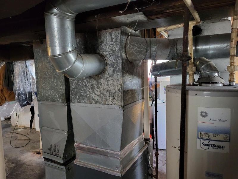 Inspected a malfunctioning furnace under 10 years old located in the customer's basement. Evaluated the existing HVAC system which includes sheet metal ductwork and connections to the main distribution system. Electrical assessment of the circuit breaker panel was performed to determine compatibility with replacement unit options.