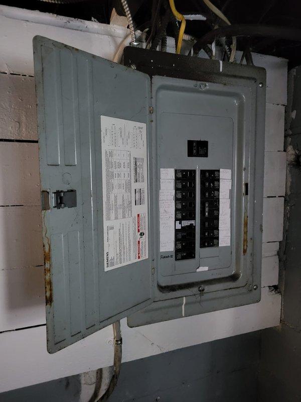 Inspected a malfunctioning furnace under 10 years old located in the customer's basement. Evaluated the existing HVAC system which includes sheet metal ductwork and connections to the main distribution system. Electrical assessment of the circuit breaker panel was performed to determine compatibility with replacement unit options.