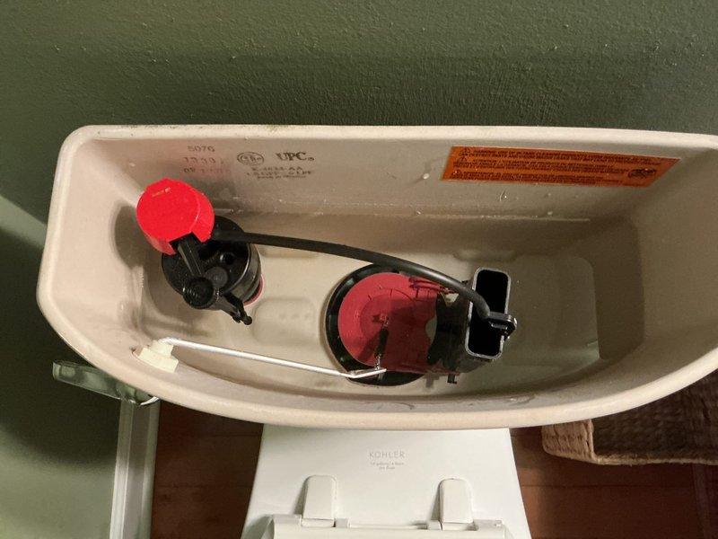 Replaced faulty fill valve assembly in Kohler toilet that was causing slow tank filling and continuous running. Adjusted water level to manufacturer specifications and replaced non-functioning shut-off valve to restore proper operation. All components tested and verified working correctly with no leaks present.