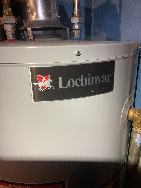 Performed routine maintenance on 14-year-old furnace system located in basement. Inspected and tested Lochinvar water heater, confirming proper operation with multimeter readings at 53.62. Completed comprehensive tune-up including evaluation of humidifier, thermostat, and hot water tank - all components functioning normally.