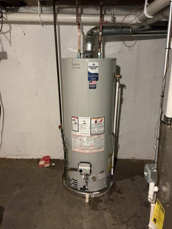 Successfully installed a 50-gallon Bradford White water heater with proper connections to existing copper and PVC piping. Installation included a drip pan with alarm system for leak protection. All supply lines, vent pipe, and connection valves were properly fitted and secured according to manufacturer specifications.