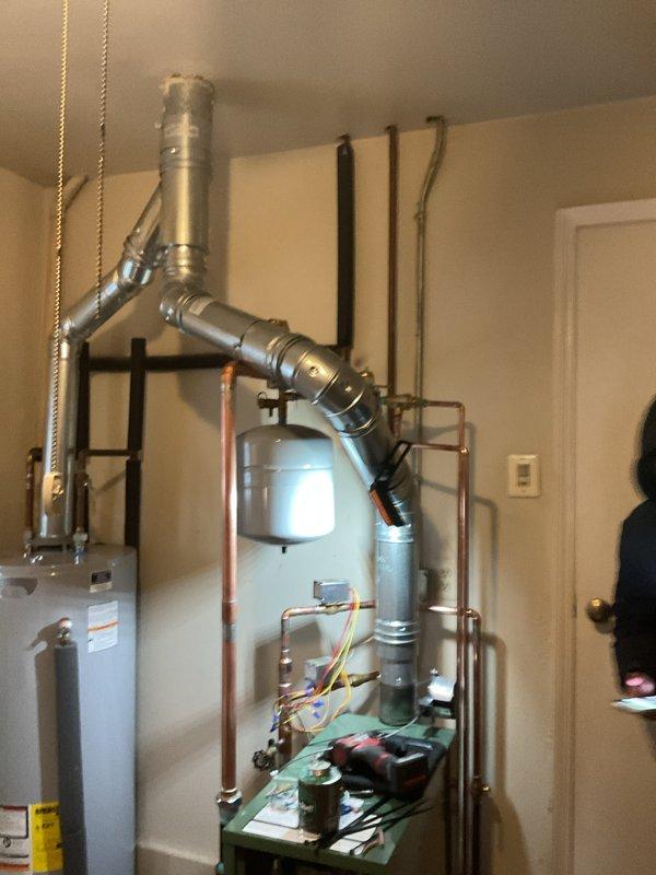 Successfully installed a new residential boiler system with complete piping configuration, including proper exhaust ventilation, expansion tank mounting, and all necessary plumbing connections. System was fully tested and verified to be operating according to manufacturer specifications, with all mechanical, electrical, and reconnection work completed to code requirements.