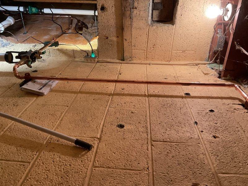 Installed water-powered backup system for sump pump with primary functionality. Completed copper pipe installation along basement wall with proper valving and connections to ensure reliable operation during power outages. System successfully tested with all connections secure and operational.