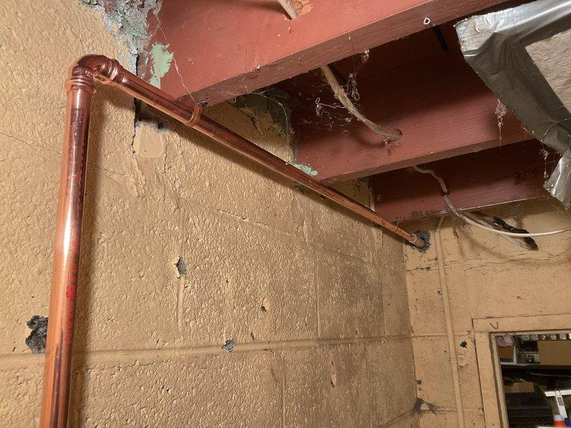 Installed water-powered backup system for sump pump with primary functionality. Completed copper pipe installation along basement wall with proper valving and connections to ensure reliable operation during power outages. System successfully tested with all connections secure and operational.