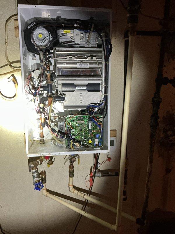 Responded to service call for intermittent operation of wall-mounted tankless water heater. Diagnosed issue by inspecting internal components including heat exchanger, circuit board, and ventilation assembly. Performed maintenance on flow sensor and cleaned scale buildup in water lines that was causing inconsistent operation. System now functioning properly with stable hot water delivery.