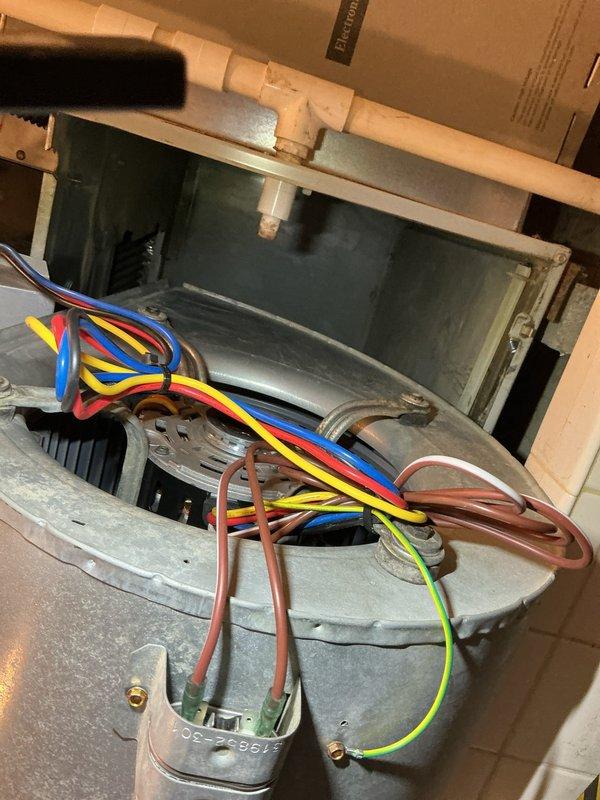Performed diagnostic evaluation on 10+ year old furnace not heating properly. Identified faulty blower motor assembly with compromised wiring connections. Replaced condensate drainage component which showed evidence of significant water damage and rust accumulation on surrounding surfaces, likely contributing to system inefficiency.
