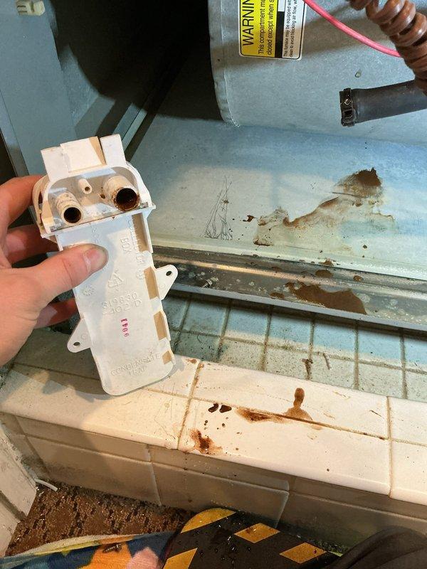 Performed diagnostic evaluation on 10+ year old furnace not heating properly. Identified faulty blower motor assembly with compromised wiring connections. Replaced condensate drainage component which showed evidence of significant water damage and rust accumulation on surrounding surfaces, likely contributing to system inefficiency.