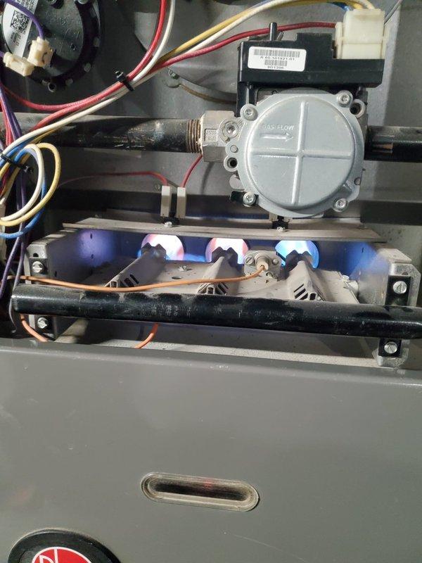 Diagnosed and serviced furnace reporting D4 error code and unusual odor from vents. Inspected gas valve and burner assembly, confirming proper flame pattern and gas flow. System is operational with normal combustion and no visible issues in the ductwork or connections to water heater.