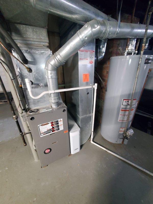 Diagnosed and serviced furnace reporting D4 error code and unusual odor from vents. Inspected gas valve and burner assembly, confirming proper flame pattern and gas flow. System is operational with normal combustion and no visible issues in the ductwork or connections to water heater.