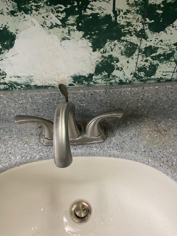 Addressed leaking bathroom faucet at the base by replacing the fixture and associated supply lines. Removed existing P-trap assembly and installed new PVC piping under the sink to remediate water damage that had caused significant wall deterioration behind the fixture. All connections were tested and verified leak-free upon completion.