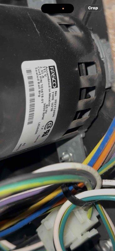 Diagnosed excessive noise from 16-year-old furnace located in utility room. Inspection revealed worn blower motor (FASCO model) with failing bearings causing the reported banging noise. Replaced blower motor assembly, reconnected wiring harness (green, yellow, blue, white, and black wires), and tested system operation. Unit now functioning properly with normal noise levels.