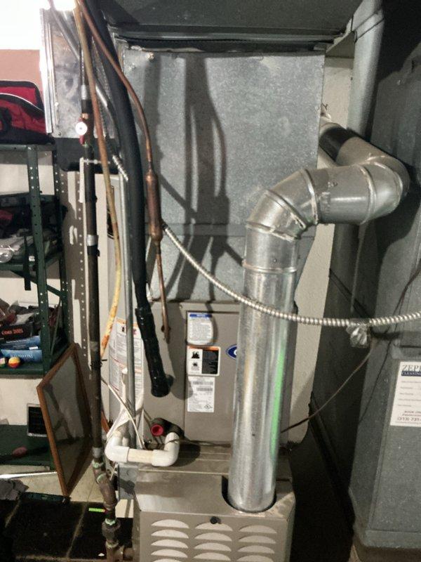 Conducted an estimate for replacement of a 20-year-old AC and furnace system located in basement. Inspection revealed an aging Zeppelin air handler with standard ductwork configuration and a gas furnace with visible wear consistent with its age. Recommended complete system replacement to improve efficiency and reliability.