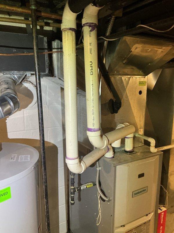 Diagnosed and repaired water leak from 10-year-old basement humidifier system. Identified faulty connection joint in PVC drainage pipe with visible residue around coupling. Properly sealed connection to prevent further water leakage, restoring normal operation of the humidifier.