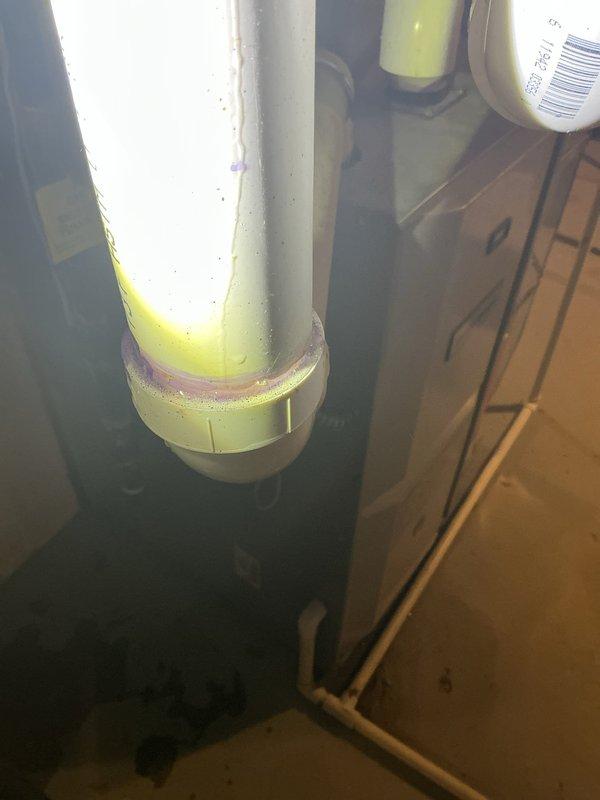 Diagnosed and repaired water leak from 10-year-old basement humidifier system. Identified faulty connection joint in PVC drainage pipe with visible residue around coupling. Properly sealed connection to prevent further water leakage, restoring normal operation of the humidifier.