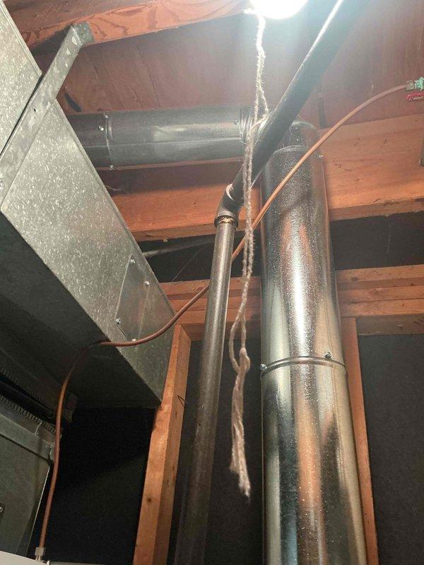 Responded to service call for one-year-old furnace with flashing red light that was still producing heat. Diagnostic testing with multimeter revealed condensation buildup on ductwork and minor electrical issues (0.16/2.1 readings). Inspected system components and resolved the warning indicator while confirming proper system operation.