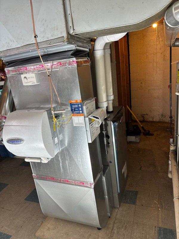 Successfully installed complete HVAC system including a 90,000 BTU furnace, 3.5-ton air conditioning unit, Carrier humidifier, and Sensi thermostat with appropriate connections to existing ductwork. System installation included proper venting with PVC pipes, electrical connections, and condensate pump setup, meeting all mechanical and electrical code requirements for residential application.