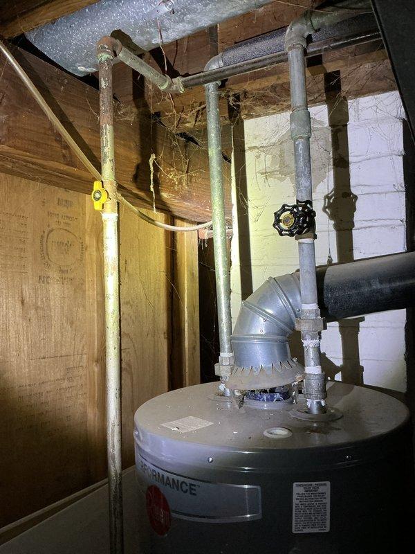 Completed Gold Furnace Inspection on a 3-year-old furnace located in the basement. System was operational with no issues identified; thermostat functioning properly at 71°F with 32% battery life remaining. Visual inspection of connected water heater and associated plumbing infrastructure revealed normal conditions with minor aging on water supply lines.